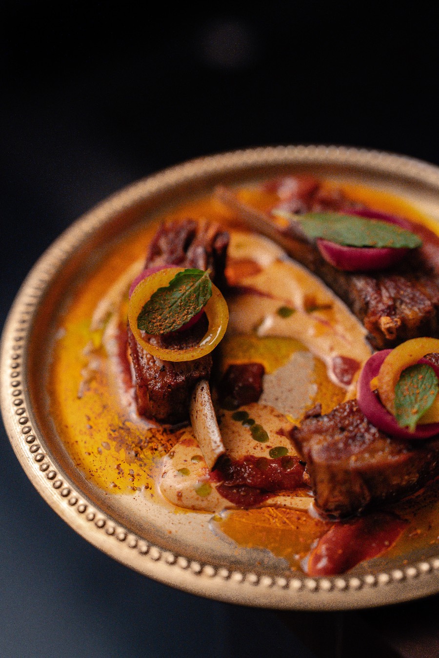 Slow-braised lamb served on a copper thali at GOAT, Auckland